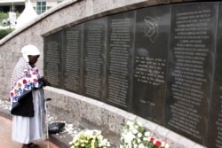 FILE - A woman prays for the victims at the memorial site in Nairobi, Kenya, Aug. 7, 2013, during events marking the 15th anniversary of the bombing of the U.S. Embassy in the city.