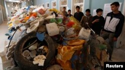 Jordanian students tour an exhibition on the amount of plastic waste in the Gulf of Aqaba and in the world's oceans in Amman.