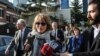 United Nations Special Rapporteur Agnes Callamard, surrounded by members of the media, walks around the Saudi Consulate, background, in Istanbul, Jan. 29, 2019. Callamard was investigating the death of Saudi journalist Jamal Khashoggi. 