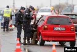 French police conduct a control at the French-German border in Strasbourg, France, to check vehicles and verify the identity of travelers as security increases after last Friday's deadly attacks in Paris, Nov. 20, 2015.