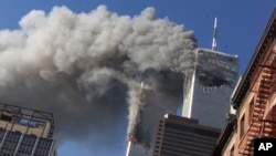 FILE - In this Sept. 11, 2001 file photo, smoke rising from the burning twin towers of the World Trade Center after hijacked planes crashed into the towers, in New York City. 