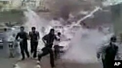 In this image grab obtained by AFPTV from YouTube on March 23, 2011, Syrian protesters run for cover from tear gas during a recent but undated demonstration in the southern town of Daraa. AFP could verify that the pictures were shot in Daraa.