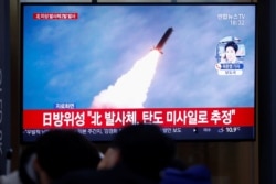 People in Seoul, South Korea, watch a TV broadcasting file footage for a news report on North Korea firing an unidentified projectile, Nov. 28, 2019.
