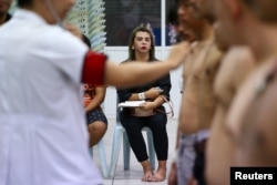 FILE - A transgender person waits for a health examination during an army draft held at a school in Klong Toey, in Bangkok, Thailand, April 5, 2017.
