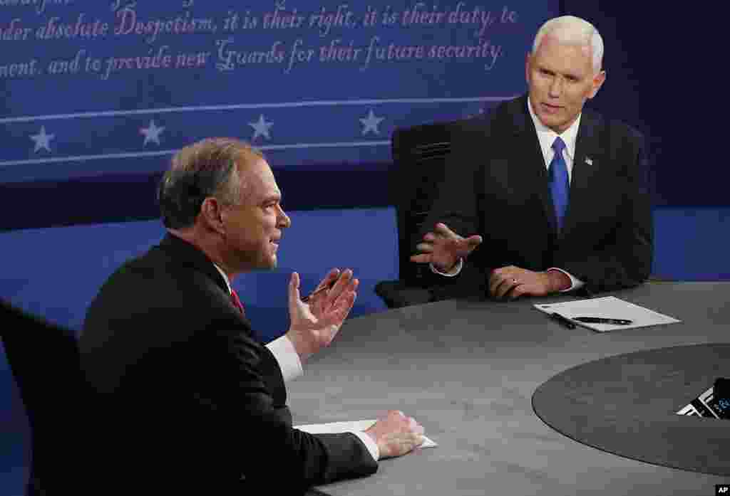 Republican vice-presidential nominee Gov. Mike Pence, right, speaks as Democratic vice-presidential nominee Sen. Tim Kaine listens during the vice-presidential debate.