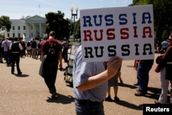Protesters gather to rally against U.S. President Donald Trump's firing of Federal Bureau of Investigation Director James Comey, outside the White House in Washington, May 10, 2017.