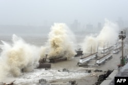 FILE - Waves lash over onto a shoreline in Mumbai on May 17, 2021, as Cyclone Tauktae, packing ferocious winds and threatening a destructive storm, surge bore down on India, disrupting the country's response to its devastating Covid-19 outbreak. (Photo by Sujit Jaiswal / AFP)