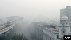 An Orange Line Metro Train is pictured on an elevated track amid smoggy conditions in Lahore, Pakistan, on November 3, 2024.