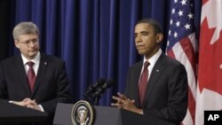 President Barack Obama and Canada's Prime Minister Stephen Harper take part in a joint news conference after their meeting at the White House in Washington, Friday, February 4, 2011