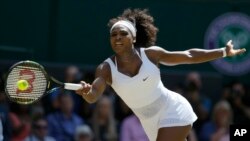 Serena Williams of the United States returns a shot to Garbine Muguruza of Spain, during the women's singles final at Wimbledon, London, Saturday July 11, 2015. (AP Photo/Kirsty Wigglesworth)