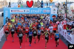 Runners compete in the Beirut Marathon, Sunday, Nov. 12, 2017. Absent from the marathon this year is the outgoing PM Saad Hariri, a regular participant, who resigned from his post unexpectedly last week while in Saudi Arabia.