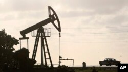 FILE - An oil well pump operates in Boca de Jaruco, Cuba, July 11, 2014. French giant Total signed a deal last year to explore for offshore oil with Cuba’s state owned CubaPetroleo.