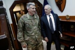 FILE - U.S. Defense Secretary James Mattis, right, and U.S. Army General John Nicholson, commander of U.S. Forces Afghanistan, arrive to meet with an Afghan defense delegation at Resolute Support headquarters, in Kabul Afghanistan, April 24, 2017.
