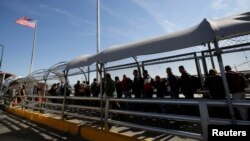 Cuban migrants queue to enter El Paso, Texas, for their appointment to request asylum in the U.S., at the Paso del Norte international border crossing bridge, in Ciudad Juarez, Mexico, April 1, 2019.