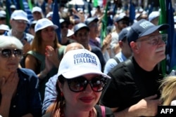 Supporters of Italian Prime Minister Giorgia Meloni attend a campaign meeting of Italian far-right party Brothers of Italy for the upcoming European elections, on June 1, 2024, in Rome.