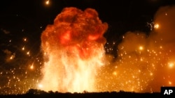 FILE - A powerful explosion is seen in the ammunition depot at a military base in Kalynivka, west of Kiev, Ukraine, early Wednesday, Sept. 27, 2017. (AP Photo/Efrem Lukatsky)