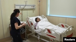 Vafa Shabanova, a passenger on the Azerbaijan Airlines plane that crashed in Kazakhstan, receives treatment at a hospital in Baku, Azerbaijan, on Dec. 27, 2024. Russian President Vladimir Putin apologized on Dec. 28 for the "tragic incident."
