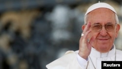 FILE - Pope Francis waves as he leads the weekly audience in Saint Peter's Square at the Vatican, April 10, 2013. 