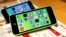 FILE - These then-new Apple iPhone 5c models were on display in at Tokyo store on Sept. 20, 2013. A 5c is at the center of Apple's battle with the FBI over efforts to break the company's proprietary auto-destruct security system. 