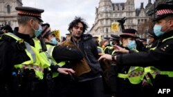 Police officers arrest a protestor during a 'Kill The Bill' protest against the Government's Police, Crime, Sentencing and Courts Bill, in central London, Apr. 3, 2021.