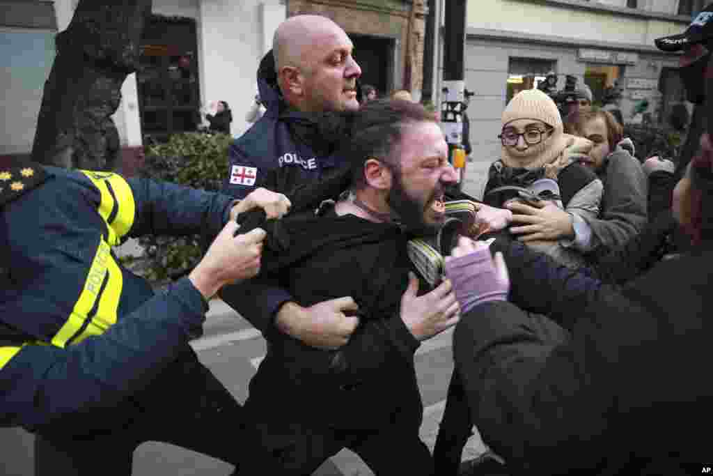 Police detain a protester during a rally against the results of the parliamentary elections amid allegations that the vote was rigged in Tbilisi, Georgia.