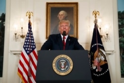 FILE - President Donald Trump pauses as he speaks about the deadly white nationalist rally in Charlottesville, Va., Aug. 14, 2017, in the Diplomatic Room of the White House in Washington.