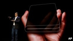 Justin Denison, SVP of Mobile Product Development, talks about the Infinity Flex Display of a folding smartphone during the keynote address of the Samsung Developer Conference, Wednesday, Nov. 7, 2018, in San Francisco. (AP Photo/Eric Risberg)