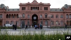 Pedestrians gather in front of the presidential palace in Buenos Aires, Argentina, Nov. 29, 2018, where world leaders will meet for two-days starting Friday. 