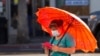 A person wearing a protective face mask uses her mobile phone during the outbreak of the coronavirus disease (COVID-19), in Los Angeles