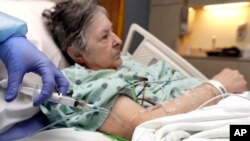 A nurse administers antibiotics to Alice McDonald at ProMedica Toledo Hospital in Toledo, Ohio. A nasty flu season is hitting U.S. hospitals.