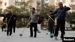 Retirees practice "Cola Ball" with music, an invented community activity in central Beijing, Oct. 17, 2013. China is close to announcing long-awaited reforms to its pension system, whose assets are estimated to have already fallen $3 trillion behind projected future payouts.