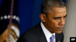 President Barack Obama listens to a question from a reporter at the White House in Washington, May 21, 2014, after he met with Veterans Affairs Secretary Eric Shinseki and Deputy Chief of Staff Rob Nabors.