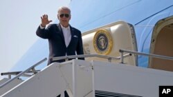 U.S.President Joe Biden waves from Air Force One on the arrival at Yokota Air Base, Sunday, May 22, 2022, in Fussa, Tokyo, Japan. (AP Photo/Evan Vucci)