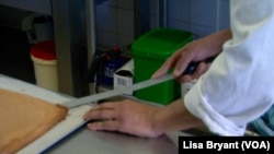 Inmate William prepares to spread cream on a lemon spongecake.