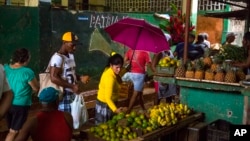 FILE - People shop at the El Egido food market in Havana, Cuba, Dec. 4, 2015.