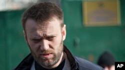 FILE - Russian opposition activist Alexei Navalny leaves a detention center in Moscow, Russia, Friday, March 6, 2015.