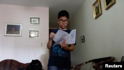 Gabriel Moncada looks at his drawings at his home in Caracas, Venezuela October 15, 2018. Picture taken October 15, 2018. REUTERS/Marco Bello