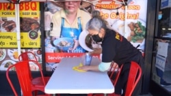 A waitress cleans up a table at Pa Ord Noodle 3, a Thai restaurant in Los Angeles, CA. Sept 2021.