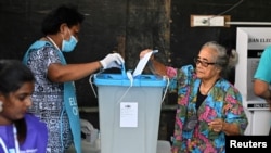 A person votes at a polling station during the Fijian general election in Suva, Fiji, Dec. 14, 2022. 