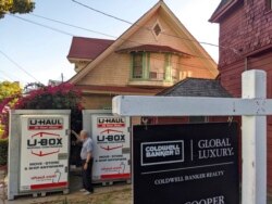 FILE - A property owner gets ready to leave after selling his single-family house in the Echo Park neighborhood of Los Angeles, March 5, 2021.