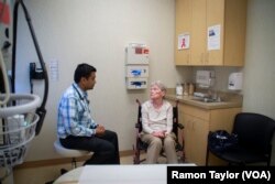 Dr. Raghav Tirupathi, an India-native physician, speaks with patient Elizabeth Jobes in Chambersburg, Pennsylvania.