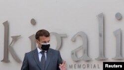 French President Emmanuel Macron speaks after signing a memorial book and laying a wreath at a mass grave containing the remains of 1994 Rwandan genocide victims, at the Kigali Genocide Memorial Center at Gisozi, in Kigali, Rwanda, May 27, 2021.