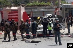 Afghanistan security forces inspect the site of a suicide attack west of Kabul, Afghanistan, May 25, 2016.