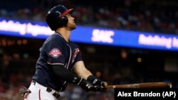 Washington Nationals center fielder Bryce Harper (34) watches his solo home run during the first inning of a baseball game against the New York Mets at Nationals Park, Wednesday, Sept. 9, 2015, in Washington.