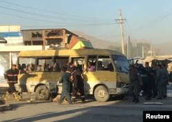 Police and fire fighters are seen at the site of a blast in Kabul, June 20, 2016.