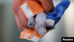 A Cataldo Ambulance medic holds used doses of naloxone after medics revived a man in his 40s who was found unresponsive from an opioid overdose in the Boston suburb of Salem, Massachusetts, Aug. 9, 2017. 