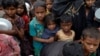 Rohingya refugees wait for food at Tengkhali camp near Cox's Bazar, Bangladesh, Dec. 8, 2017. 