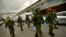 Members of the Military Emergency Unit, walking with special equipment to disinfect areas to prevent the spread of the coronavirus, arrive at Abando train station, in Bilbao, northern Spain, March 23, 2020. 