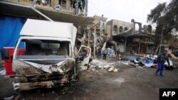 People gather at the site of car bomb attack in the Amil neighborhood in Baghdad, Iraq, March 21, 2017.
