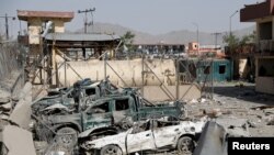 Damaged police vehicles are seen at the site of a blast in Kabul, Afghanistan, Aug. 7, 2019. 